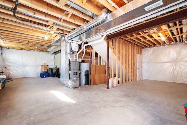 basement featuring water heater and heating unit