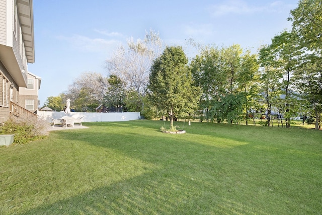 view of yard featuring fence and a patio