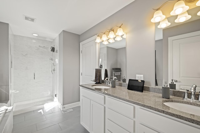 full bath with a shower stall, a sink, visible vents, and double vanity