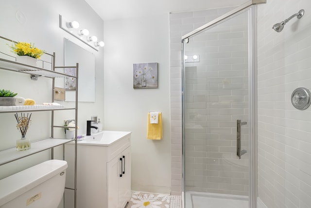 bathroom with vanity, toilet, and an enclosed shower