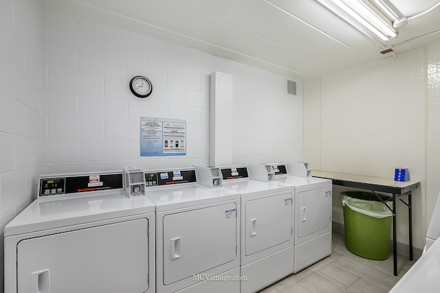 clothes washing area with washer and clothes dryer