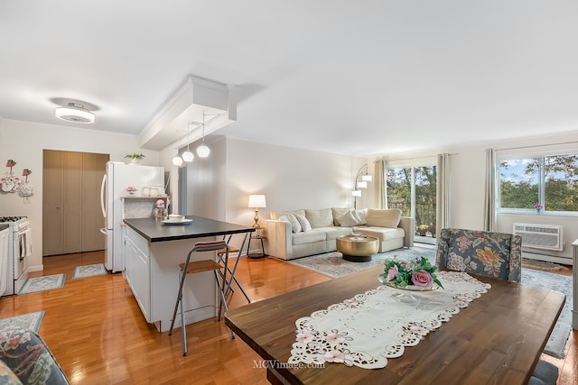 living room featuring light hardwood / wood-style floors and a wall mounted AC