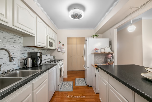 kitchen featuring light hardwood / wood-style floors, white cabinetry, white appliances, crown molding, and sink