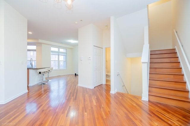 unfurnished room featuring light hardwood / wood-style flooring and sink