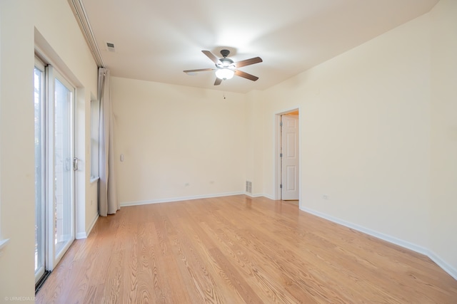 empty room featuring ceiling fan and light hardwood / wood-style floors