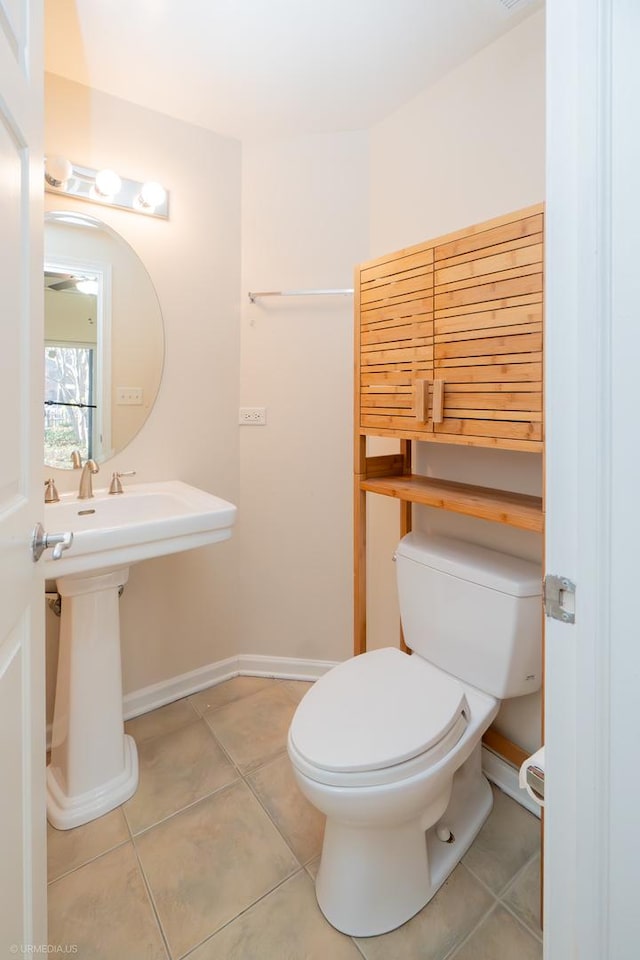 bathroom with tile patterned flooring and toilet