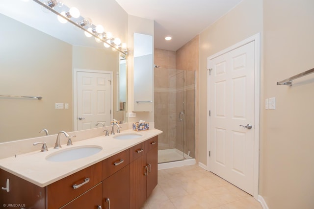 bathroom featuring tile patterned floors, vanity, and a shower with shower door