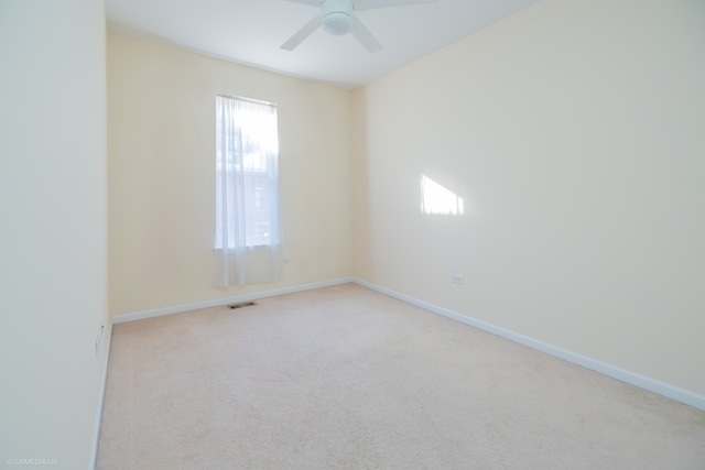 unfurnished room featuring light colored carpet and ceiling fan