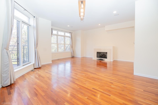 unfurnished living room featuring light hardwood / wood-style floors and a healthy amount of sunlight