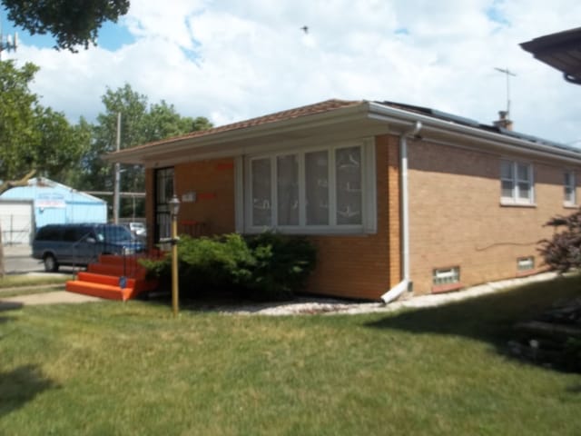 view of property exterior featuring a lawn and a garage