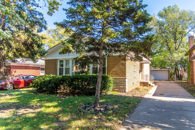 view of front of house with a garage and a front lawn