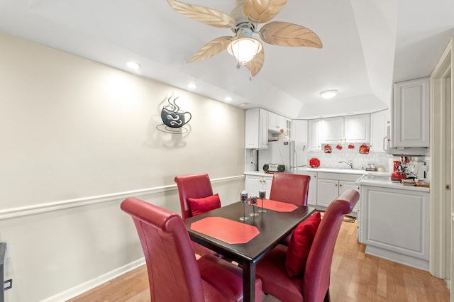 dining space featuring light hardwood / wood-style flooring, ceiling fan, and sink