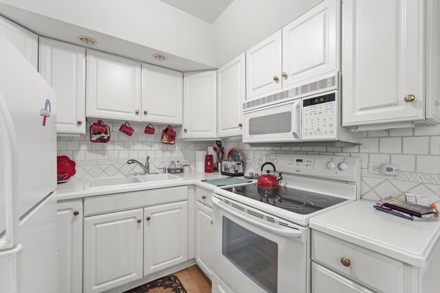 kitchen with white cabinets, white appliances, and sink