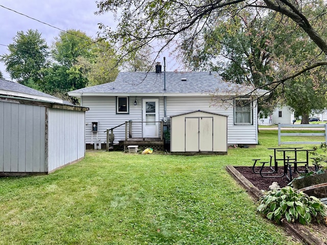 back of house featuring a yard and a storage shed