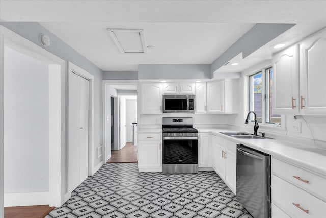 kitchen with white cabinets, appliances with stainless steel finishes, and sink