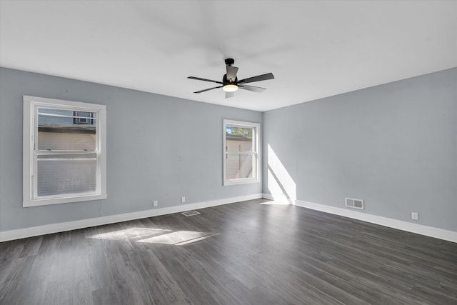 unfurnished room with ceiling fan and dark hardwood / wood-style flooring