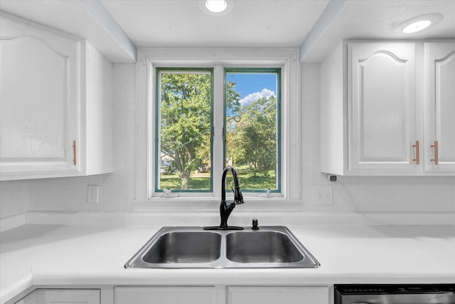 kitchen featuring a wealth of natural light, sink, and white cabinetry