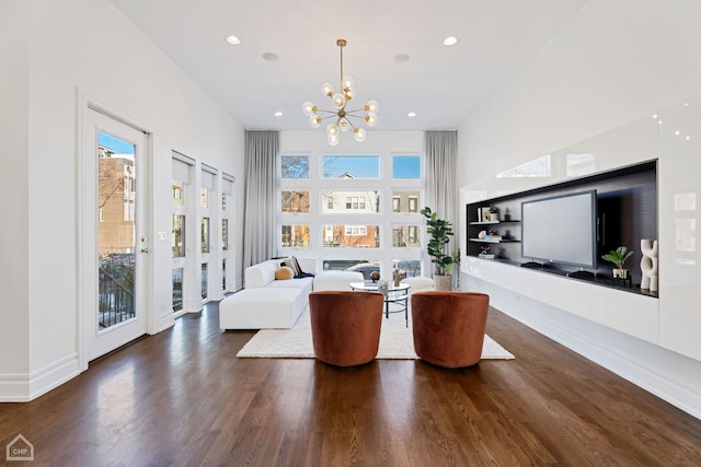 living room with a notable chandelier and dark hardwood / wood-style flooring