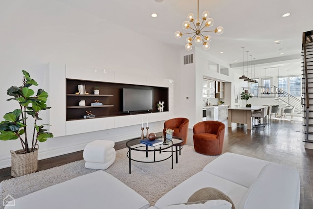 living room featuring dark wood-type flooring, a notable chandelier, and sink