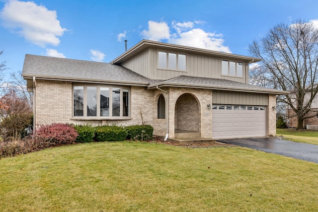 split level home featuring a front yard and a garage