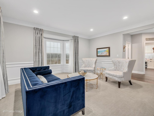 living room with crown molding and a healthy amount of sunlight