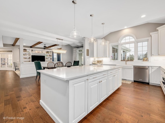 kitchen featuring hardwood / wood-style flooring, dishwasher, a center island, white cabinets, and decorative light fixtures