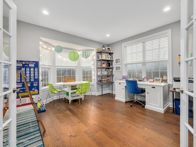 office with french doors, plenty of natural light, and light wood-type flooring