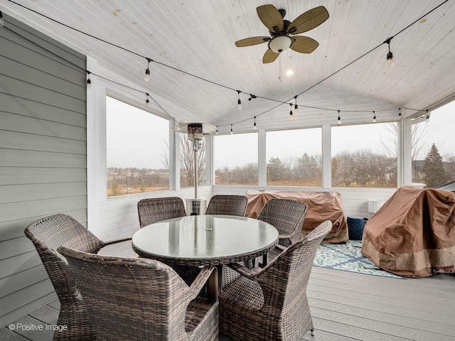 sunroom / solarium with wood ceiling, vaulted ceiling, and ceiling fan