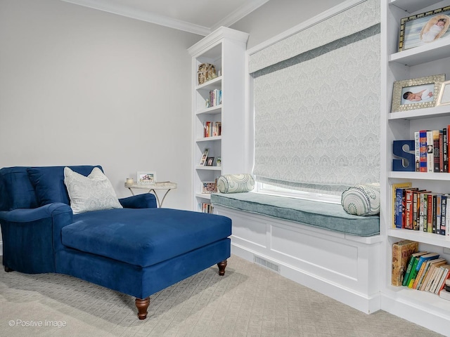 living area featuring built in shelves, ornamental molding, and carpet flooring