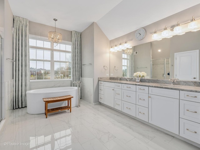 bathroom featuring lofted ceiling, vanity, and independent shower and bath