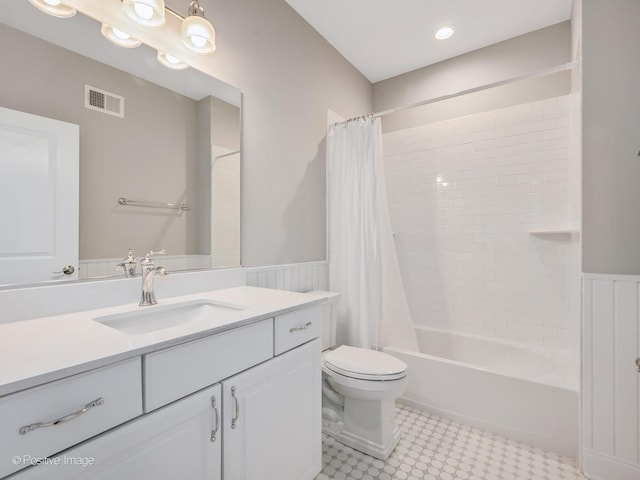 full bathroom featuring vanity, shower / bathtub combination with curtain, and toilet