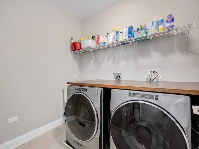 washroom with light tile patterned flooring and washing machine and clothes dryer