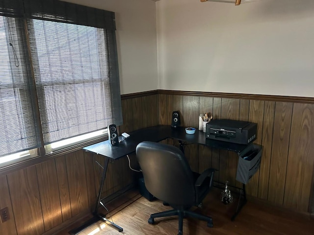 office space featuring wooden walls and light hardwood / wood-style flooring