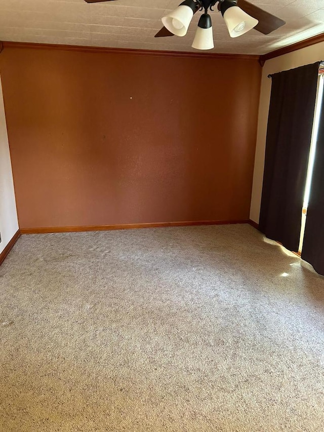 unfurnished room featuring carpet, ornamental molding, and ceiling fan