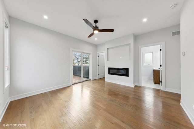 unfurnished living room with wood-type flooring and ceiling fan