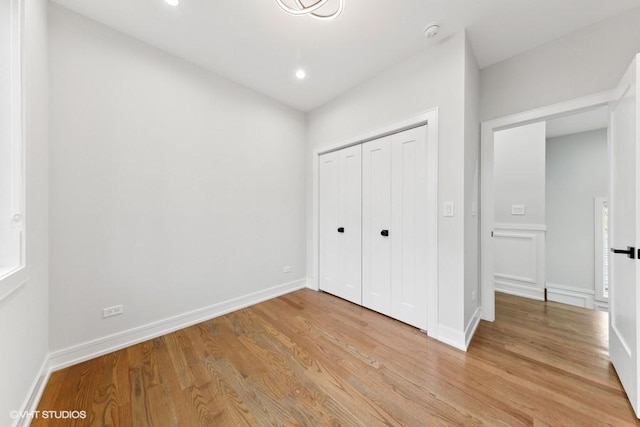 unfurnished bedroom with light hardwood / wood-style floors and a closet