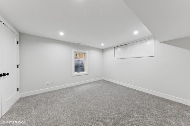 basement featuring light colored carpet