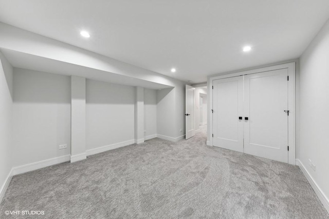 basement featuring light colored carpet