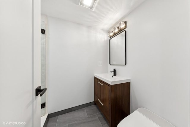 bathroom with tile patterned floors, vanity, and toilet