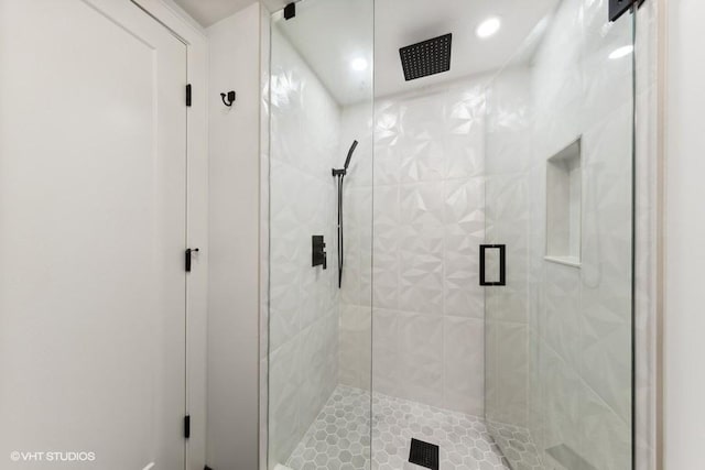 bathroom featuring a shower with shower door