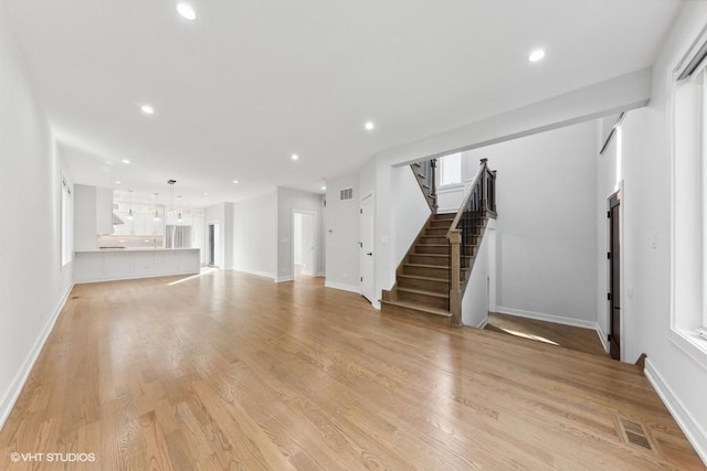 unfurnished living room featuring light hardwood / wood-style floors and a wealth of natural light