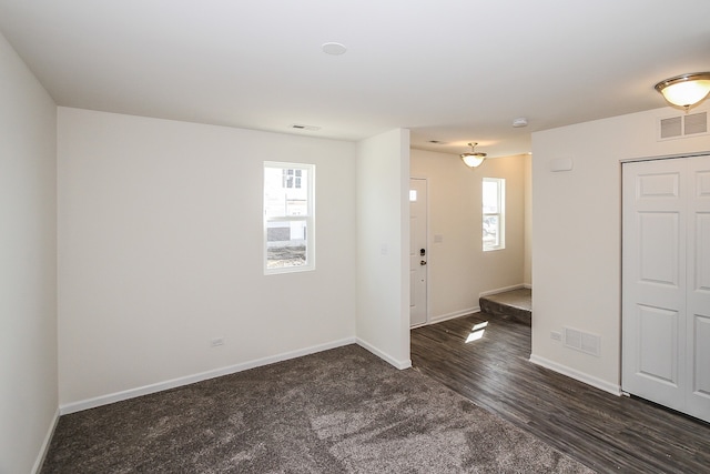 spare room featuring dark wood-type flooring