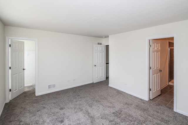 unfurnished room with dark colored carpet