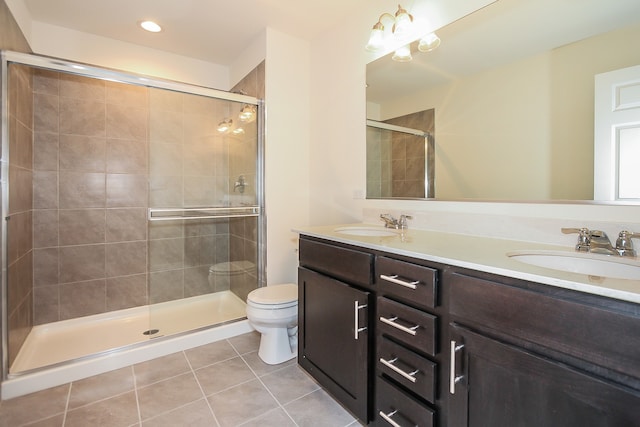 bathroom featuring tile patterned floors, a shower with shower door, vanity, and toilet