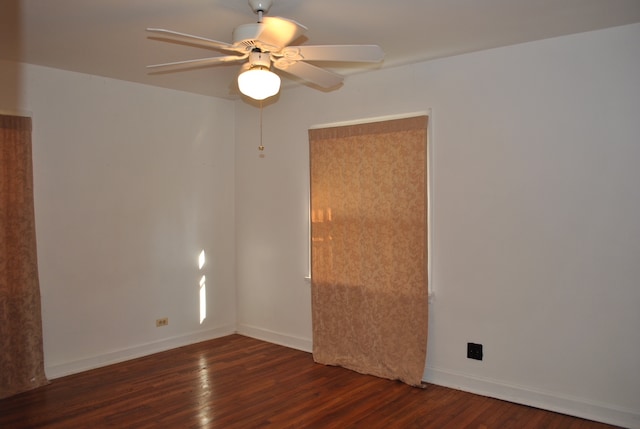 unfurnished room featuring ceiling fan and dark hardwood / wood-style flooring