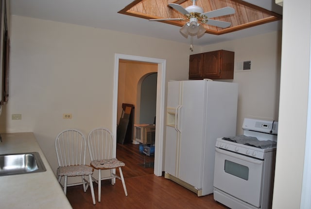 kitchen with wood-type flooring, white appliances, and ceiling fan