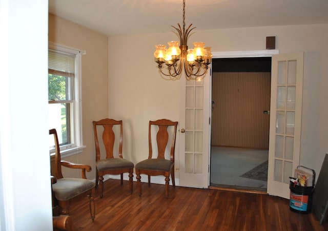 sitting room featuring a chandelier and dark hardwood / wood-style floors