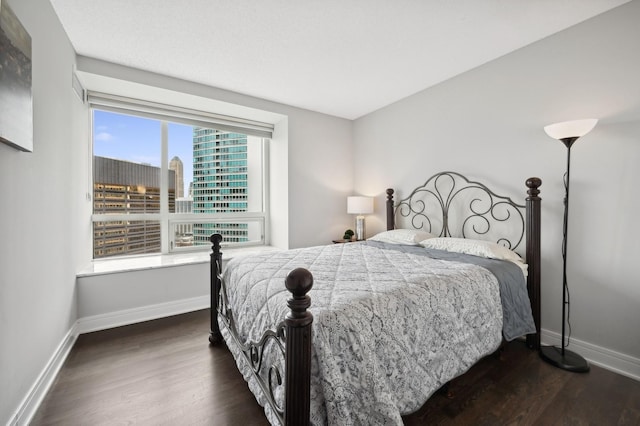 bedroom with dark wood-type flooring