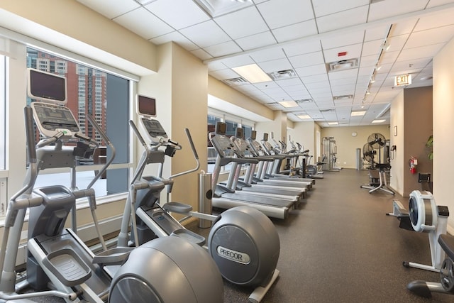 exercise room featuring track lighting and a drop ceiling