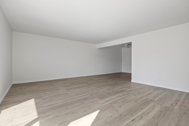 spare room featuring ceiling fan and light wood-type flooring